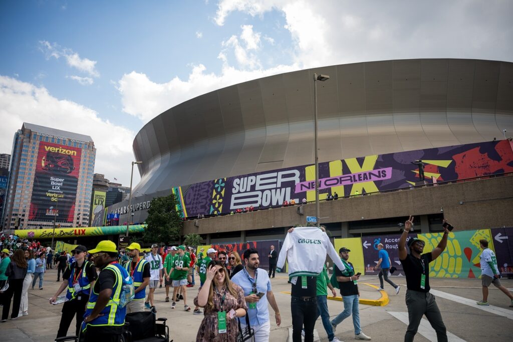 Caesar's Super Dome with fans gathering, decked out with Super Bowl LIX promotional branding